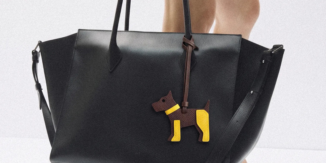 a dog raffia charm on a black leather bag