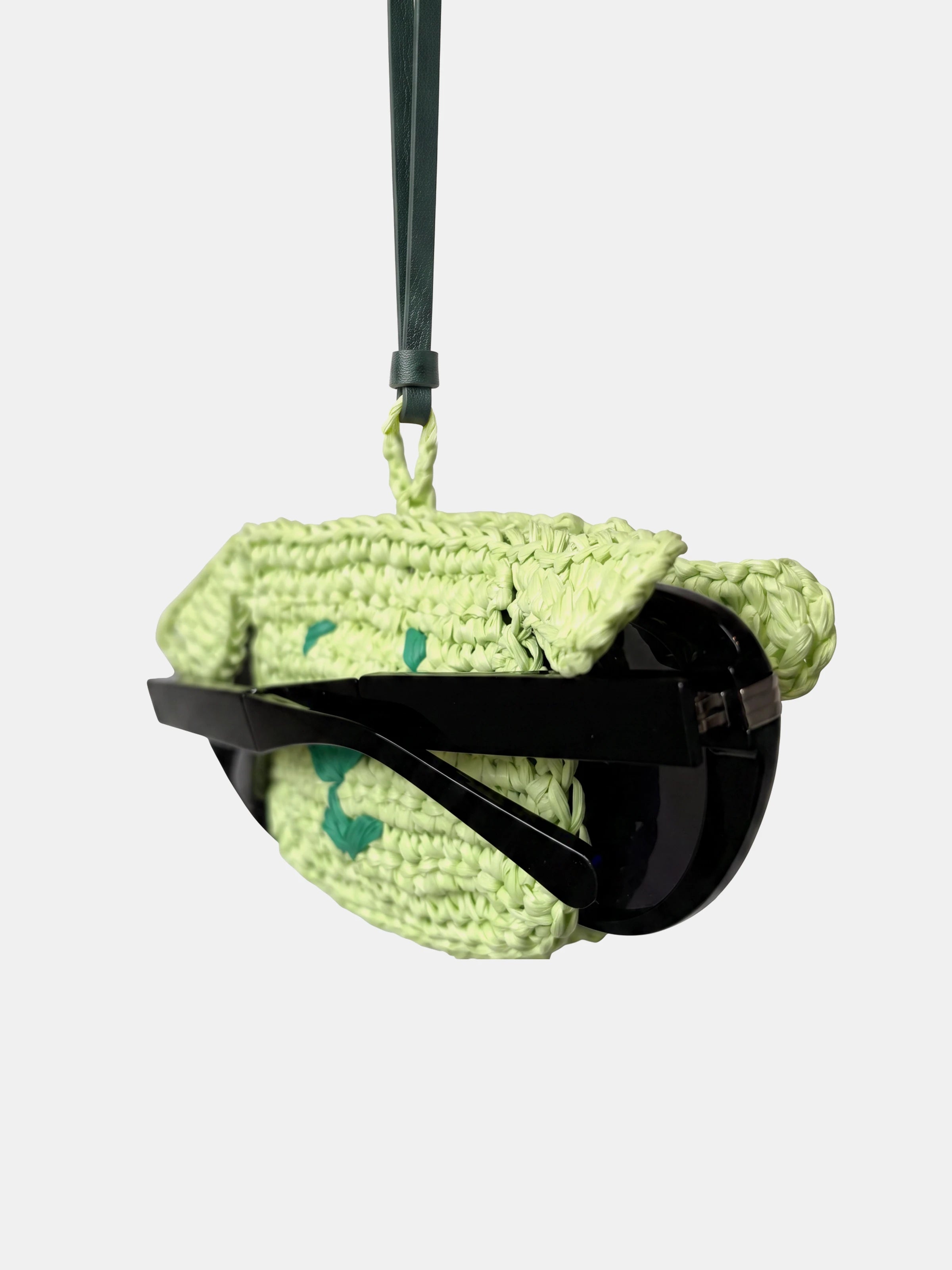 a light green dog charm that holds glasses