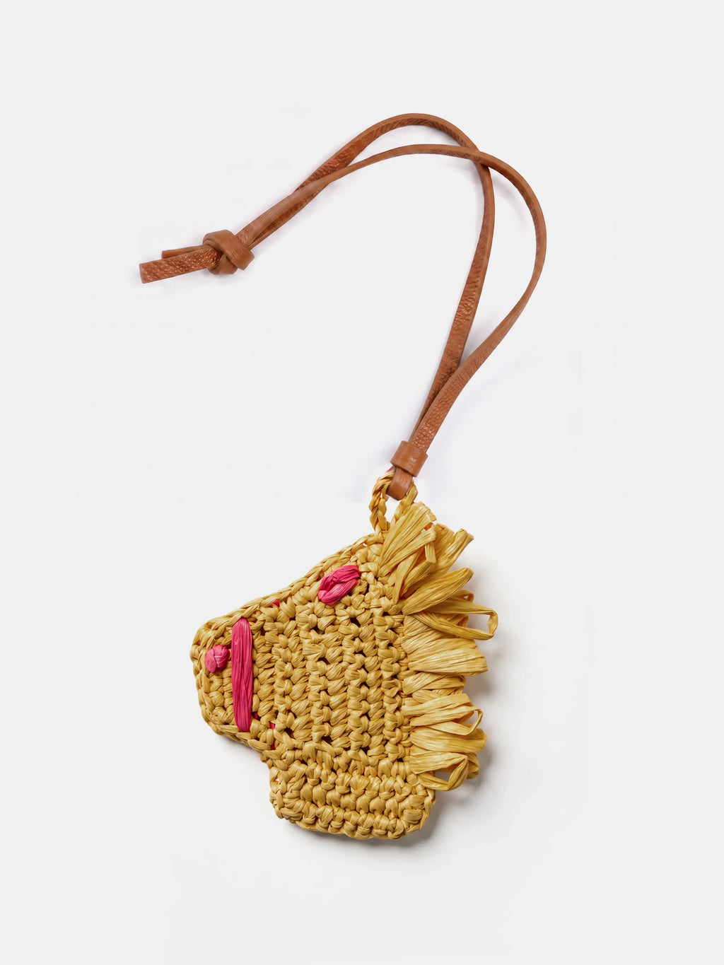 A small woven raffia horse charm with a brown leather strap, shown on a light gray background.