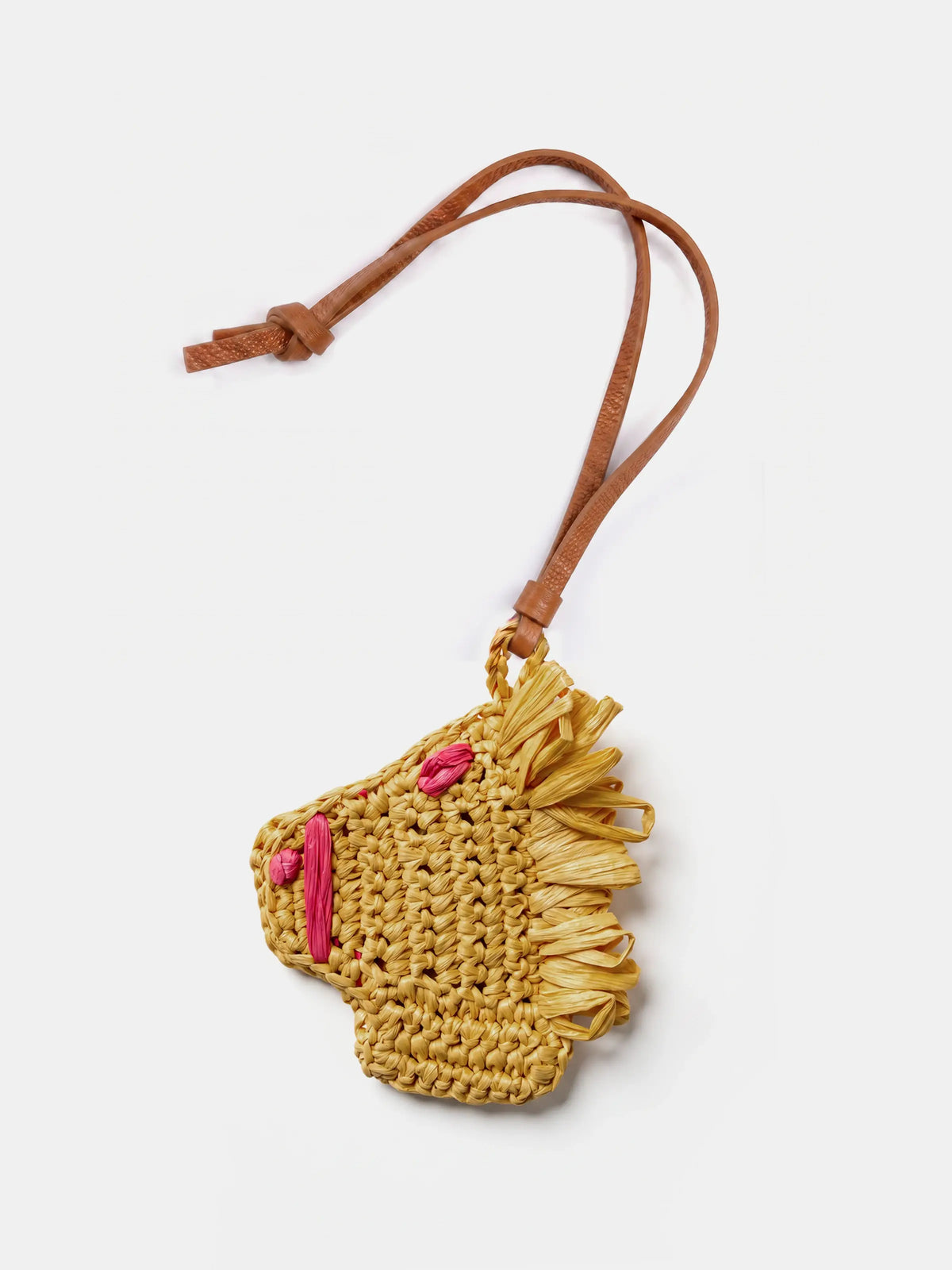 A small woven raffia horse charm with a brown leather strap, shown on a light gray background.
