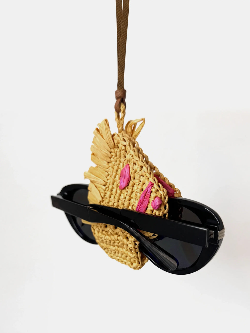 A woven raffia horse charm that holds glasses