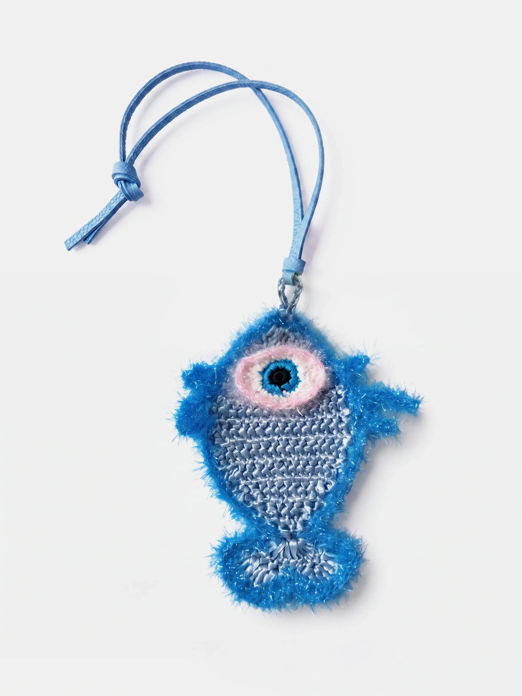 a blue raffia fish charm with an evil eye