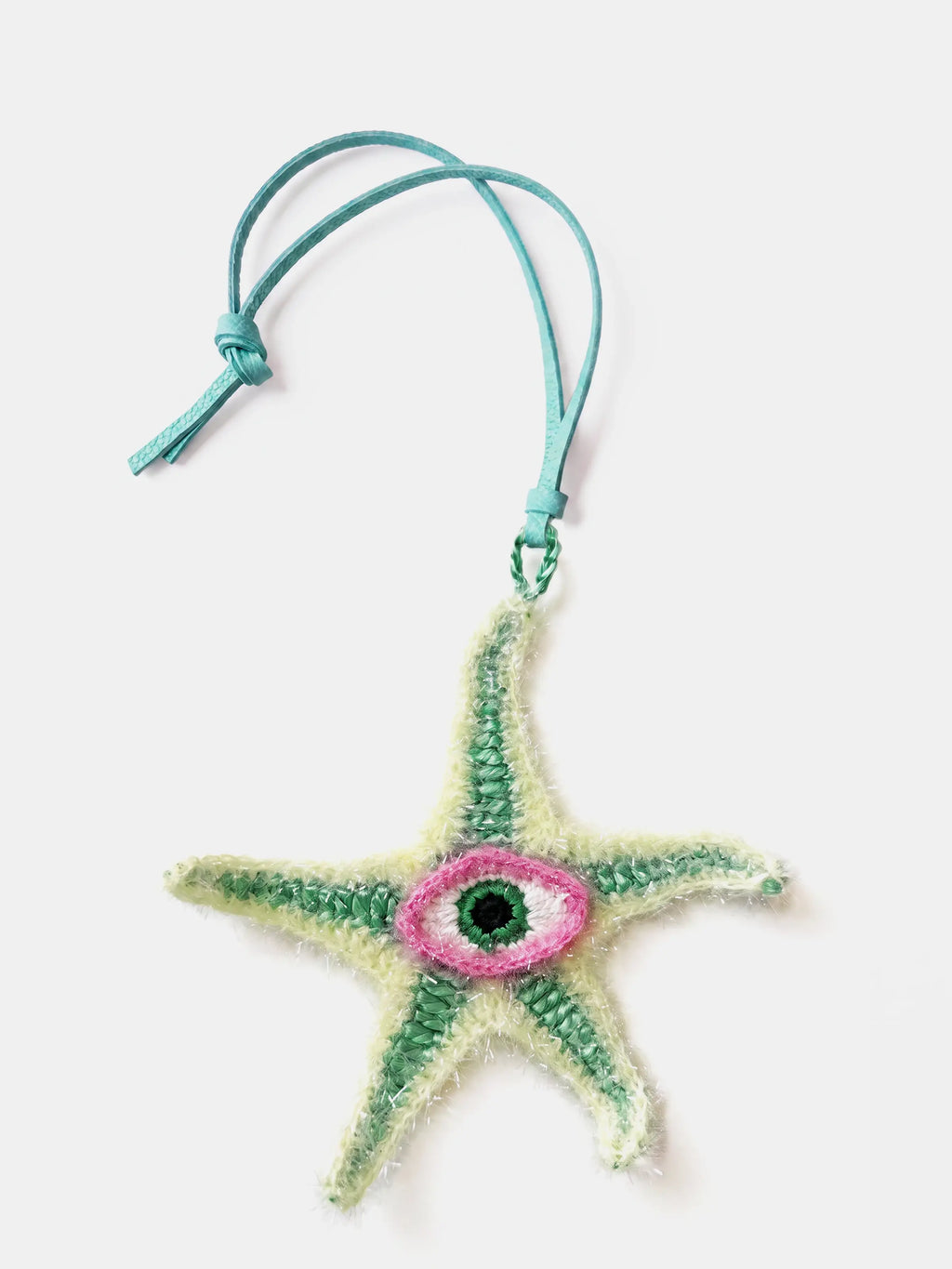 A handmade raffia starfish bag charm with a turquoise leather hanging cord