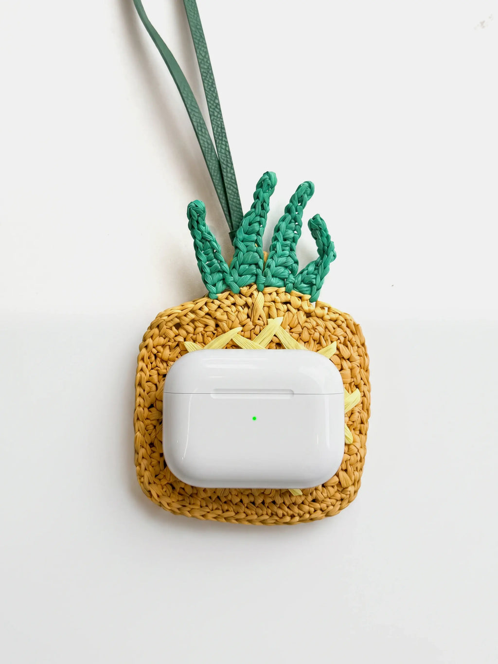 AirPods Pro on a yellow bag charm and pouch