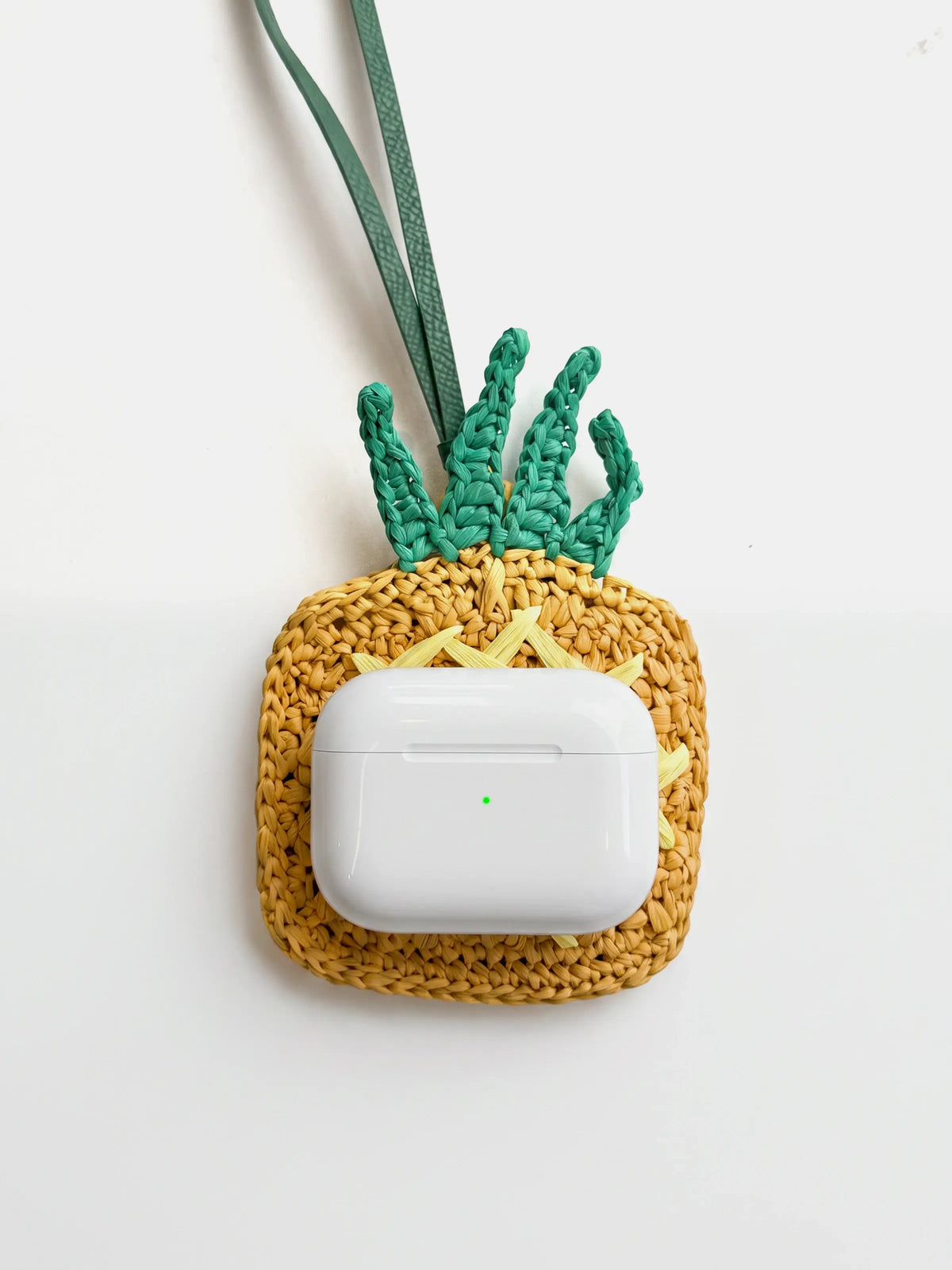 AirPods Pro on a yellow bag charm and pouch