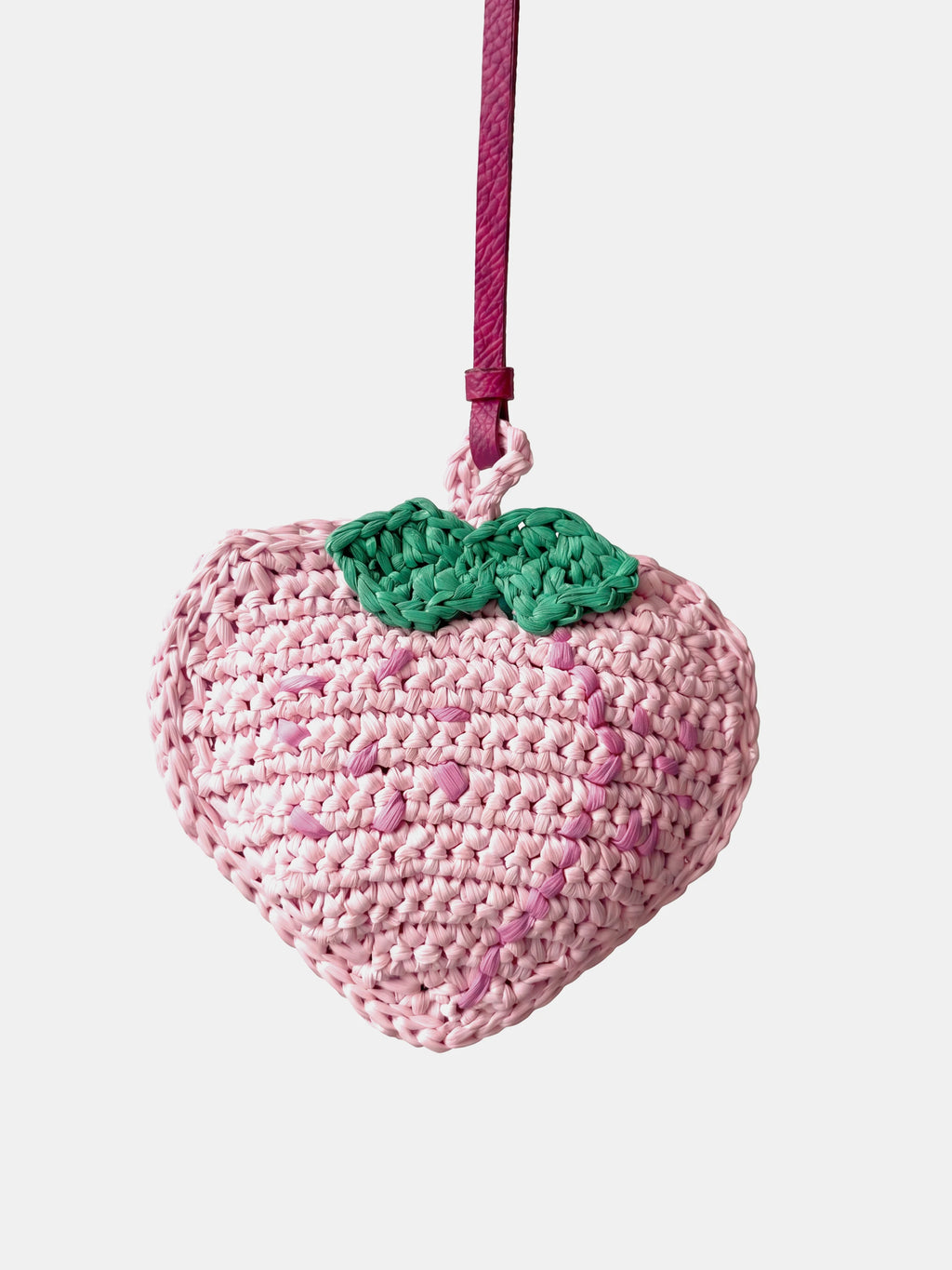 a pink peach raffia charm that holds earbuds