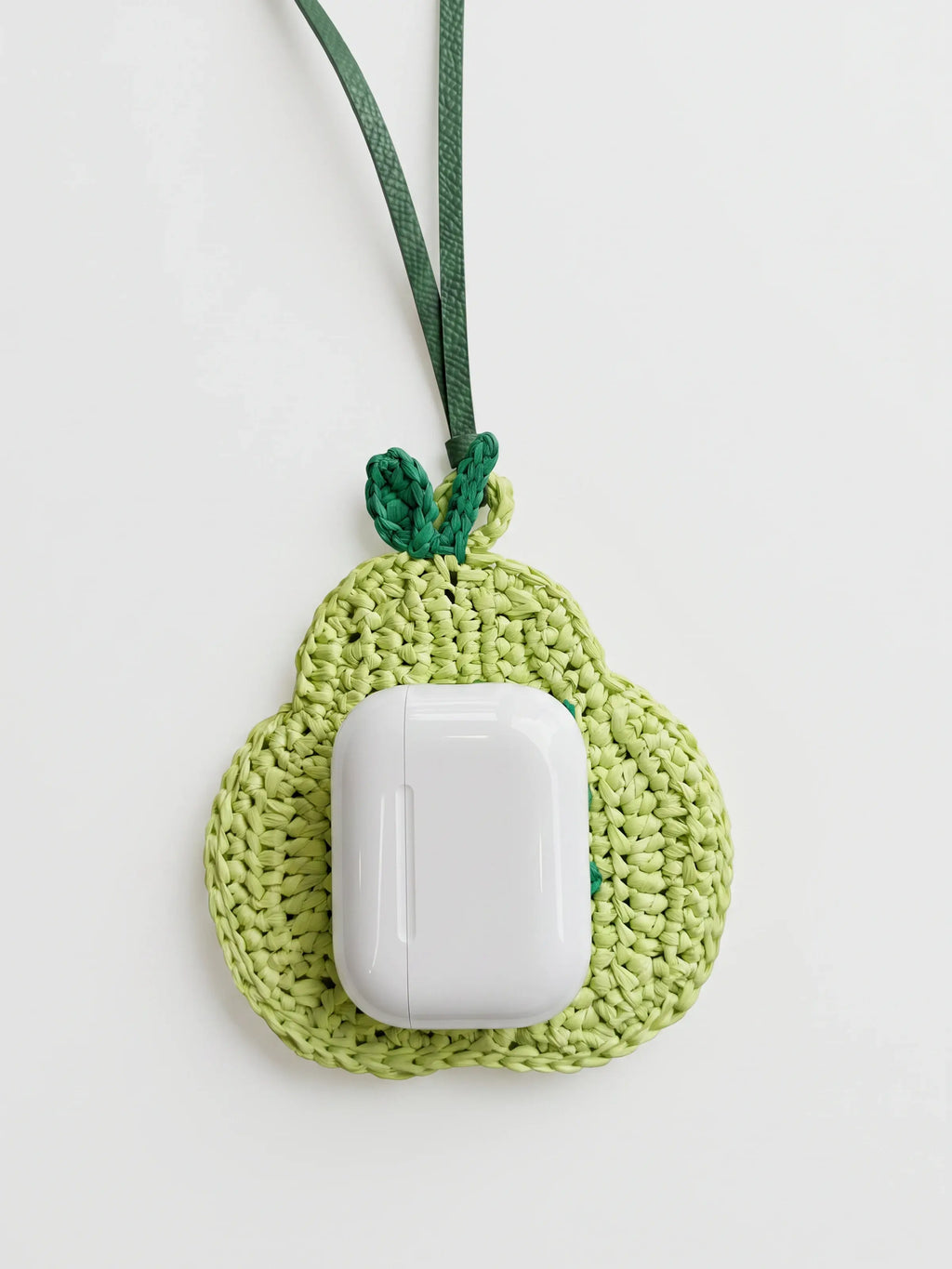 A light green pear charm with AirPods Pro