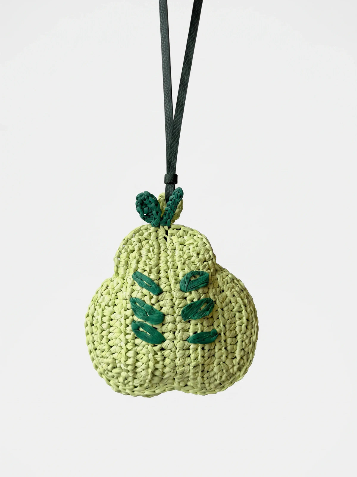 A light green crocheted raffia pear bag charm and earbuds holder.