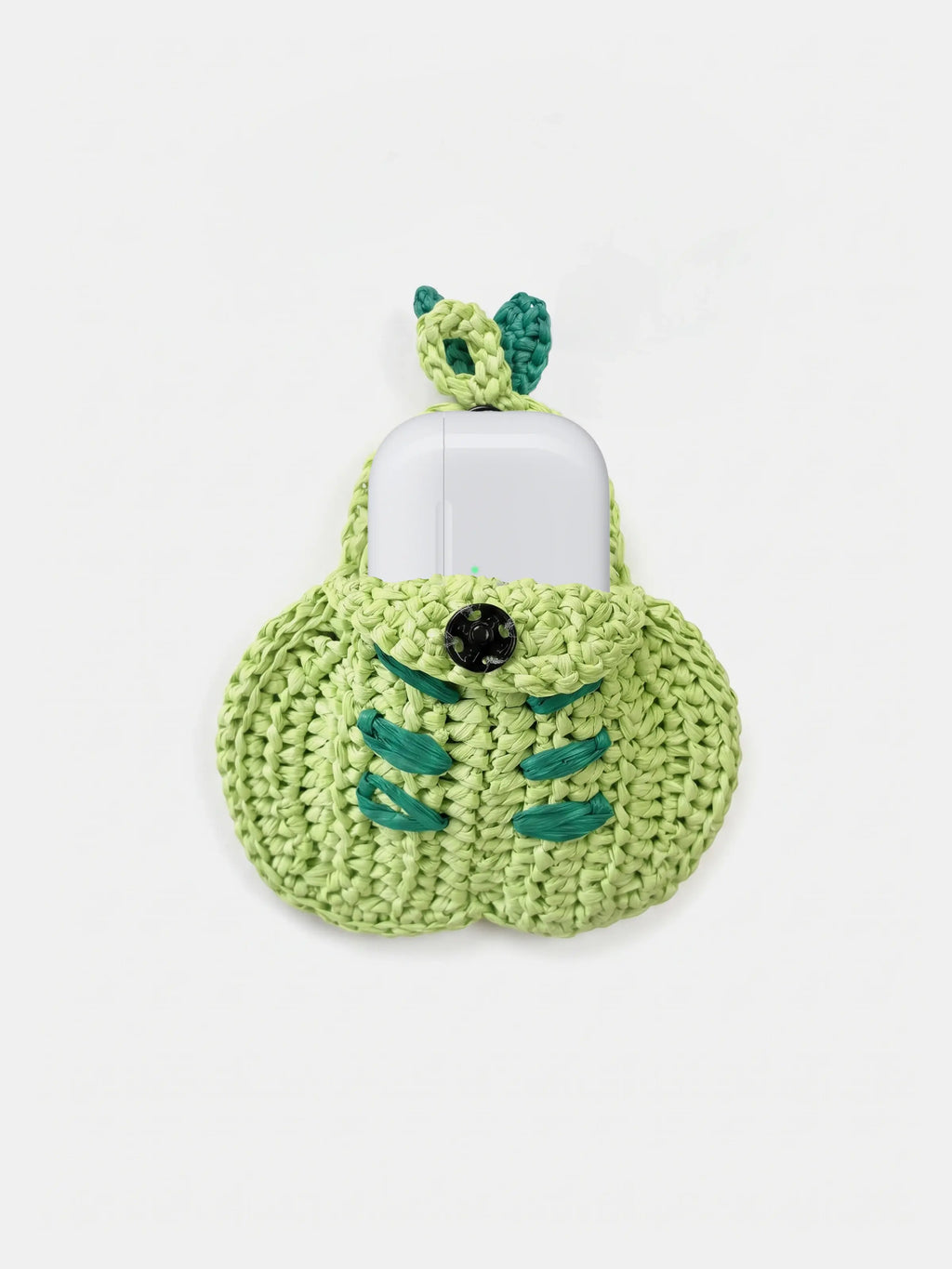 A green pear bag charm that holds AirPods Pro