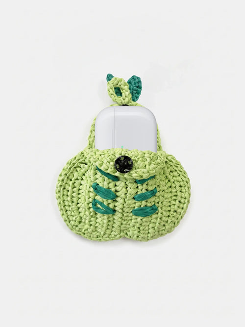 A green pear bag charm that holds AirPods Pro