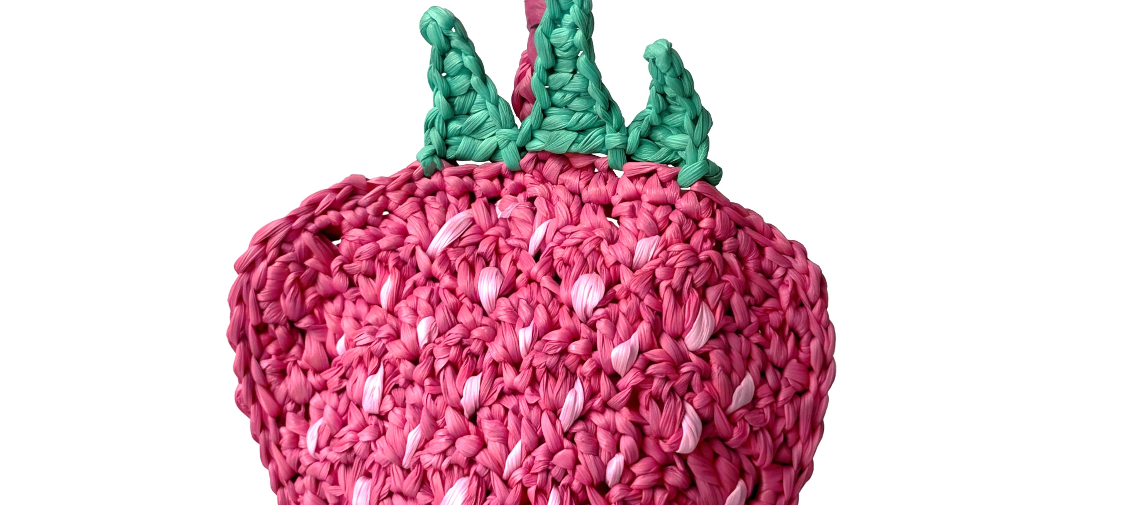 a pink and red woven strawberry raffia cham