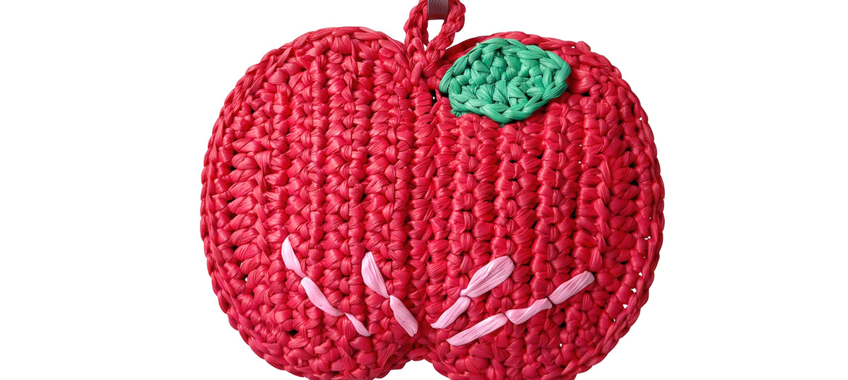 a red woven apple charm