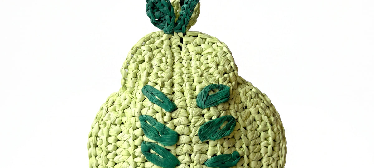 a woven green pear raffia charm