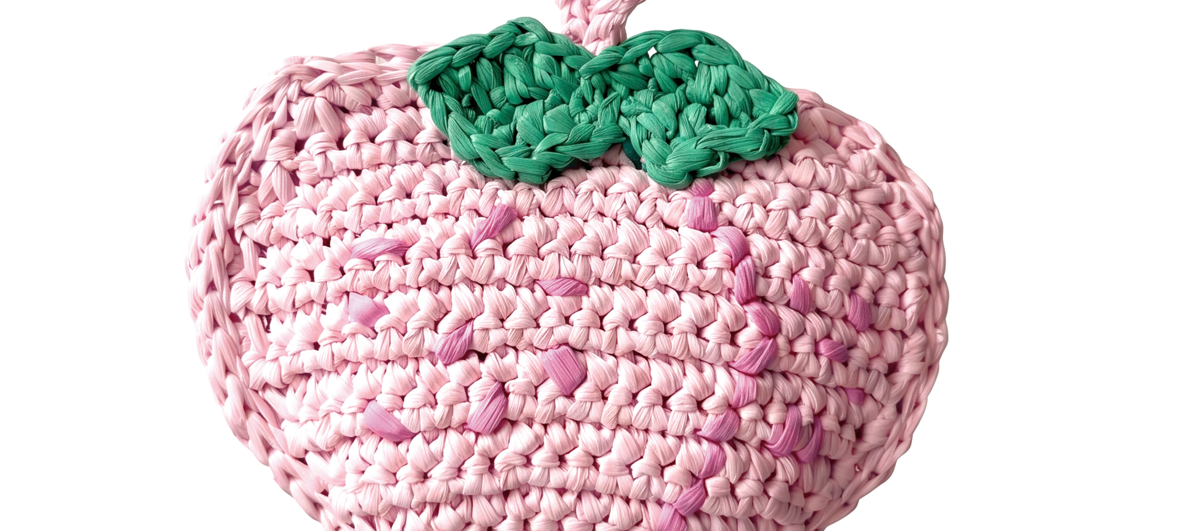 a pink woven peach bag charm