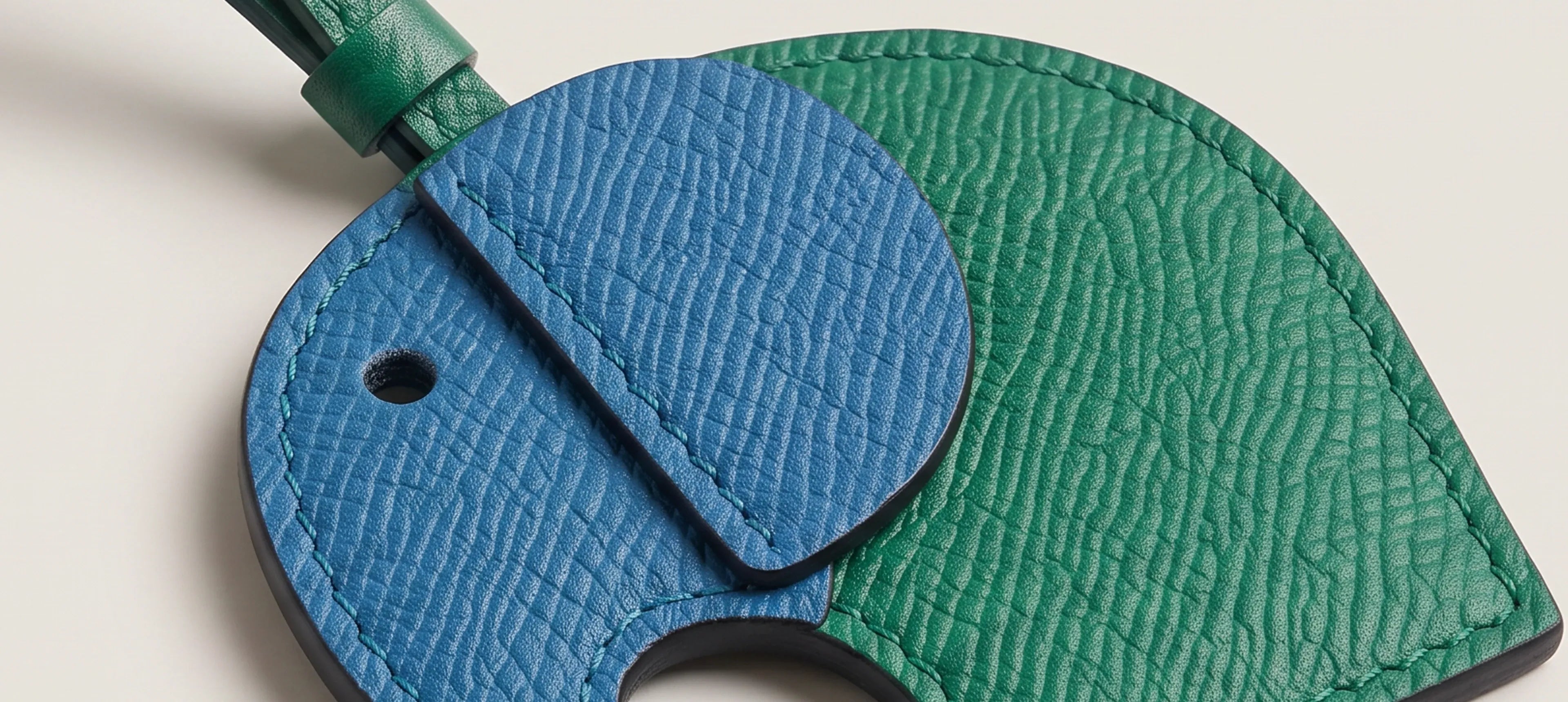 details of a blue and green leather elephant charm